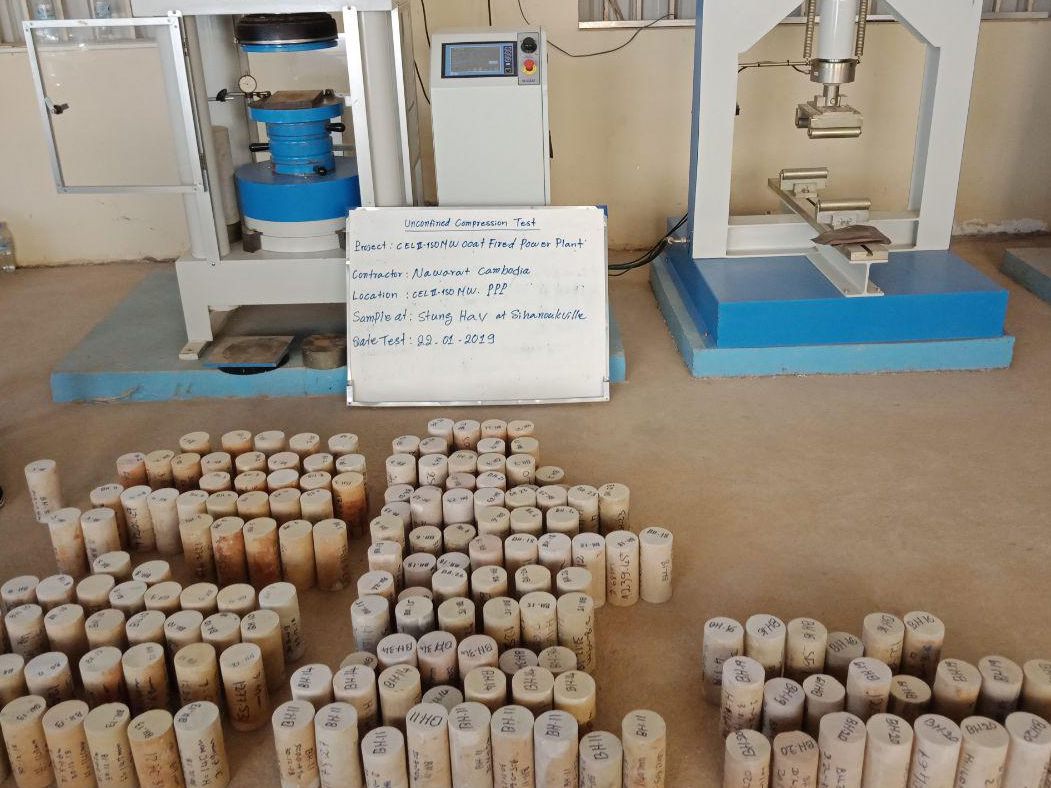 Compression testing frame with concrete cylinders